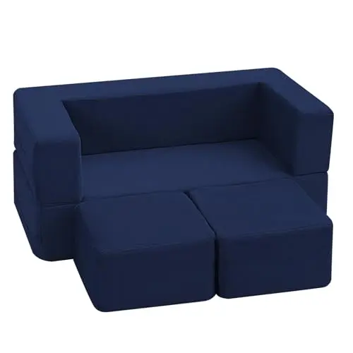 Navy blue MeMoreCool kids couch glowing with star patterns in a dark room.