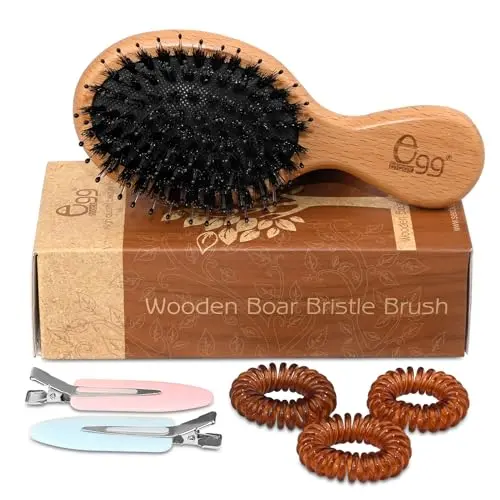 BLACK EGG Mini Hair Brush showing compact design and bristles