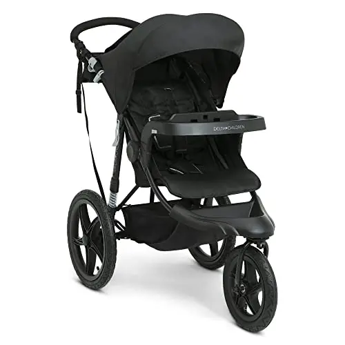 Delta Children Apollo jogging stroller in black on a forest gravel trail