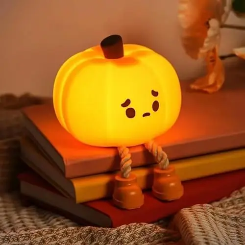 Dylviw Pumpkin Night Light glowing on a bedside table