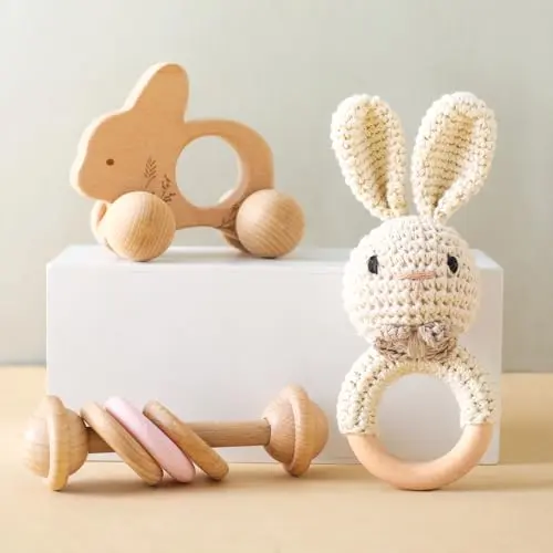 Set of three baby rattles: a crochet rabbit, a wooden push car, and a silicone ring