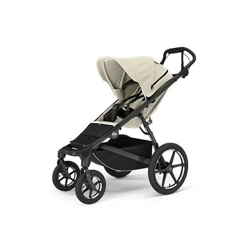 Thule Urban Glide 4-wheel jogging stroller in Soft Beige on a path