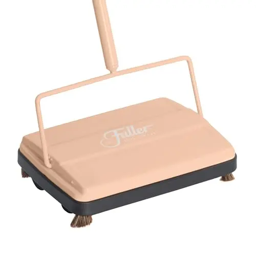 Fuller Brush 17073 electrostatic carpet sweeper in peach with a dual dust bin and cleaning comb.