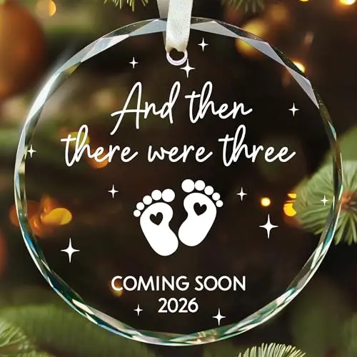 SUCHAGIFT clear glass Christmas ornament with 'Baby Arriving 2026' and stork design, hanging from a beige string